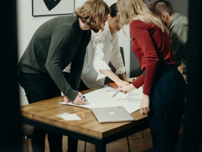 Group of diverse professionals brainstorming ideas in a stylish modern office space.